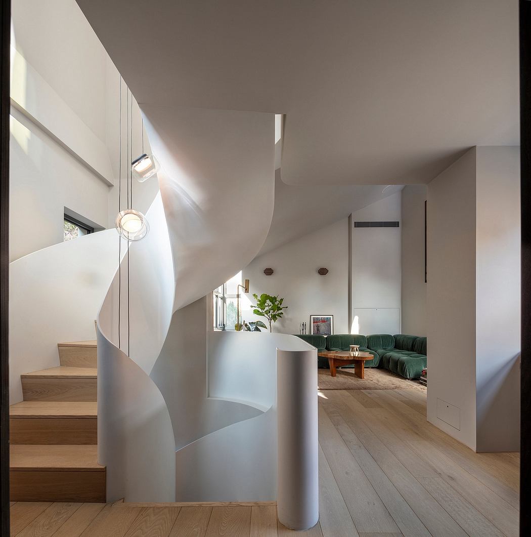 Striking modern interior with curved staircase, timber floors, and furniture.