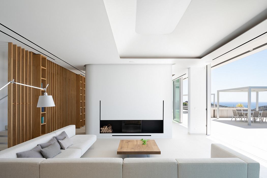 Sleek, modern living room with wooden paneling, large fireplace, and access to outdoor terrace.