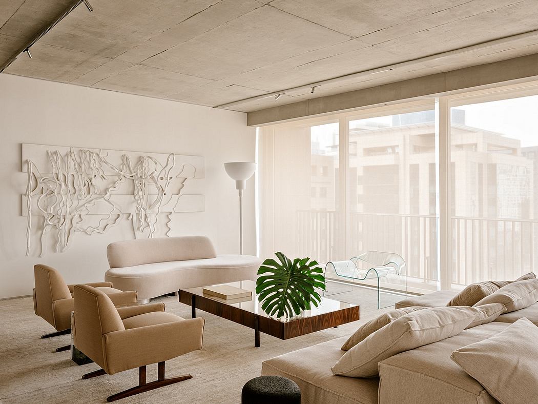 A spacious living room with concrete ceiling, floor-to-ceiling windows, and minimalist decor.