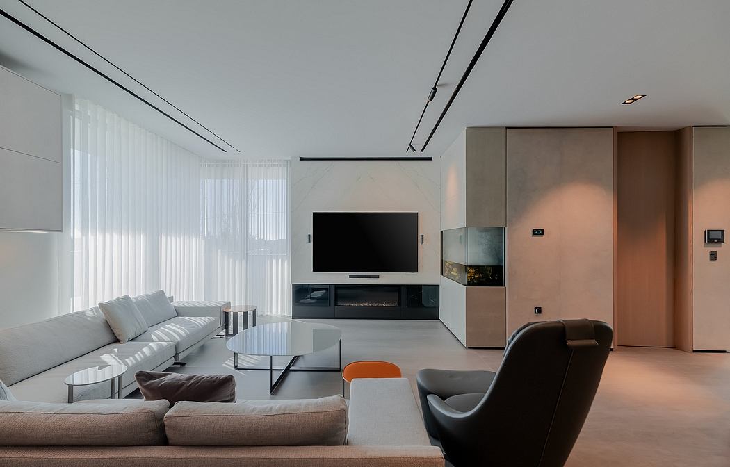 Sleek, modern living room with minimalist furniture, TV stand, and warm lighting accents.