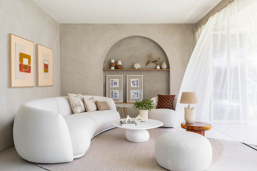 Neutral-toned living room with arched shelving, minimal decor, and cozy seating.