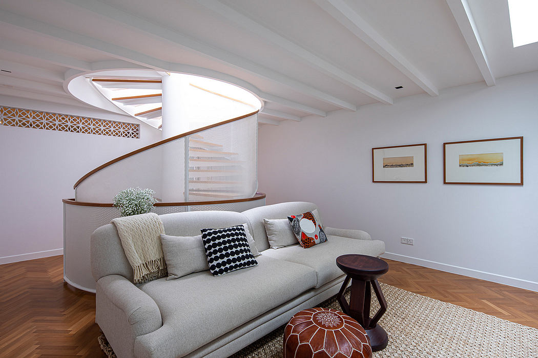 Modern spiral staircase, patterned tiles, and neutral-toned living space.
