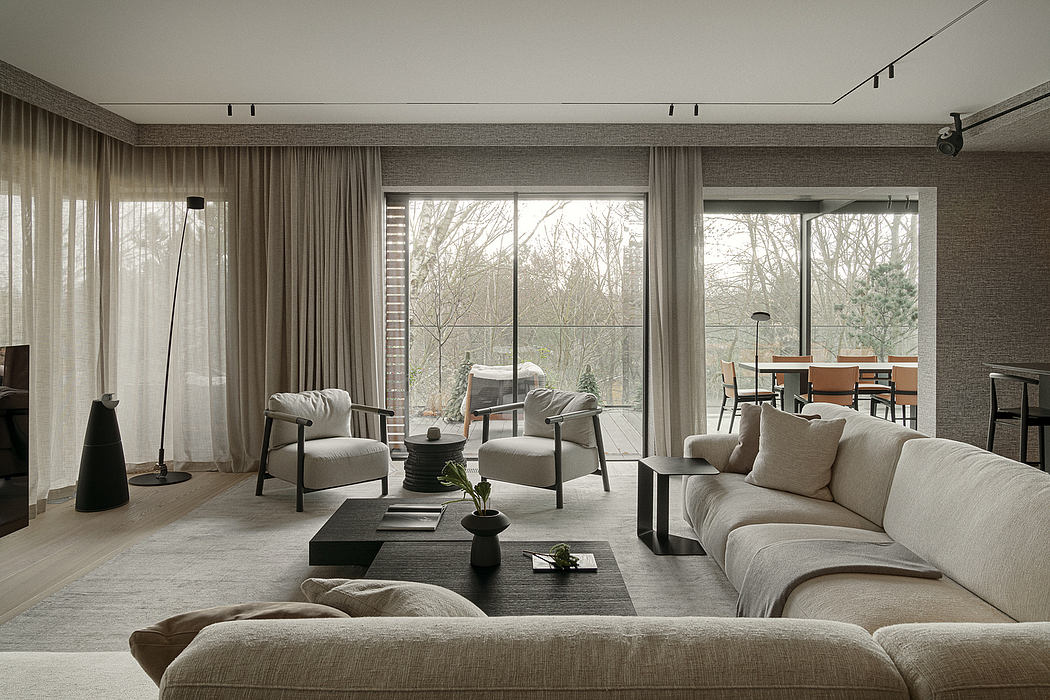 Elegant living room with large windows, plush seating, and a minimalist, contemporary design.
