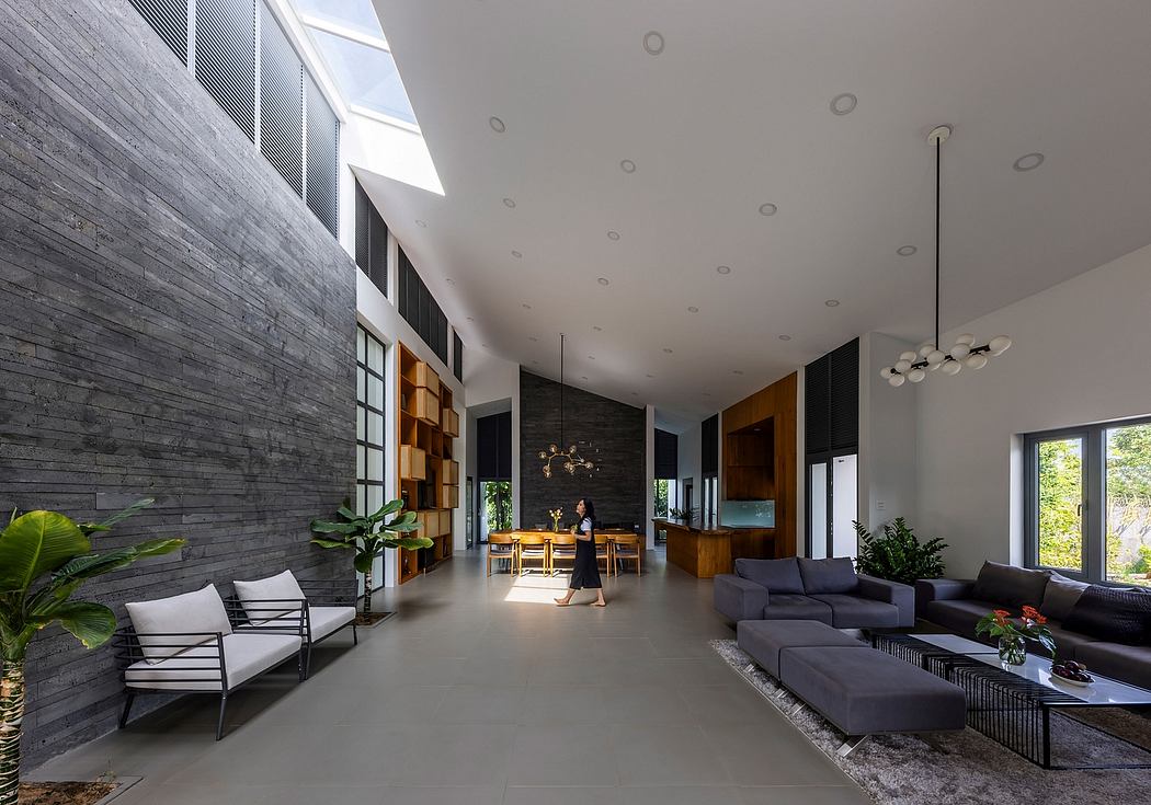 Sleek, minimalist interior with concrete walls, large windows, and modern furnishings.