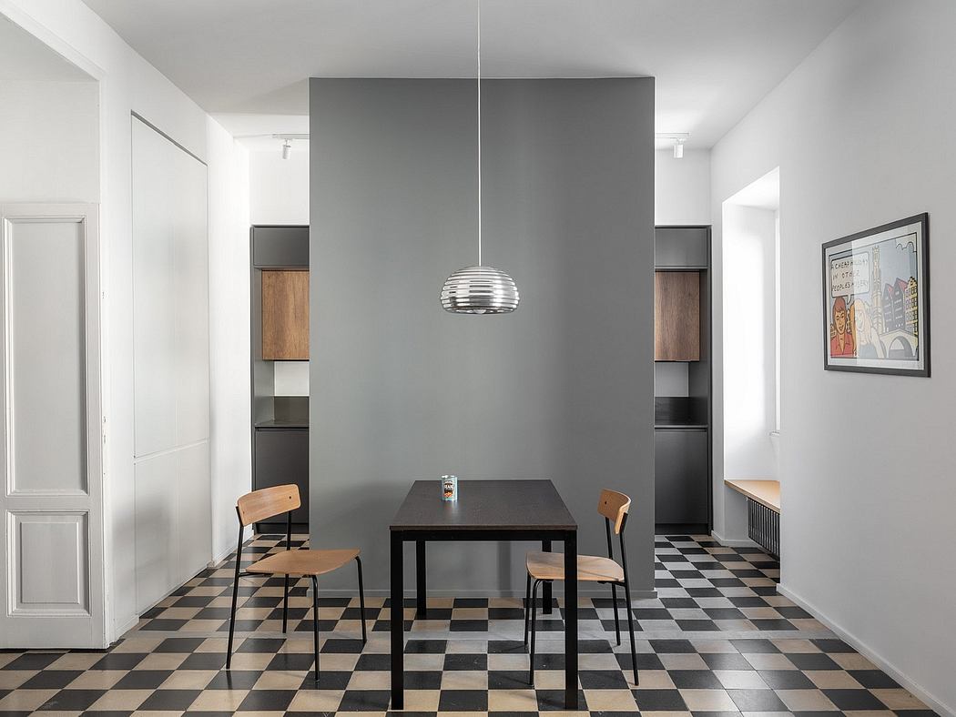A modern dining room with a checkered tile floor, a black table, and wooden chairs. A sleek pendant light fixture hangs above the table.