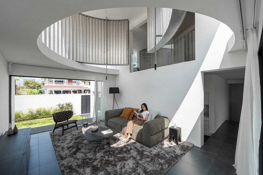 Curved steel beams form an elegant ceiling over a modern living room with plush seating.