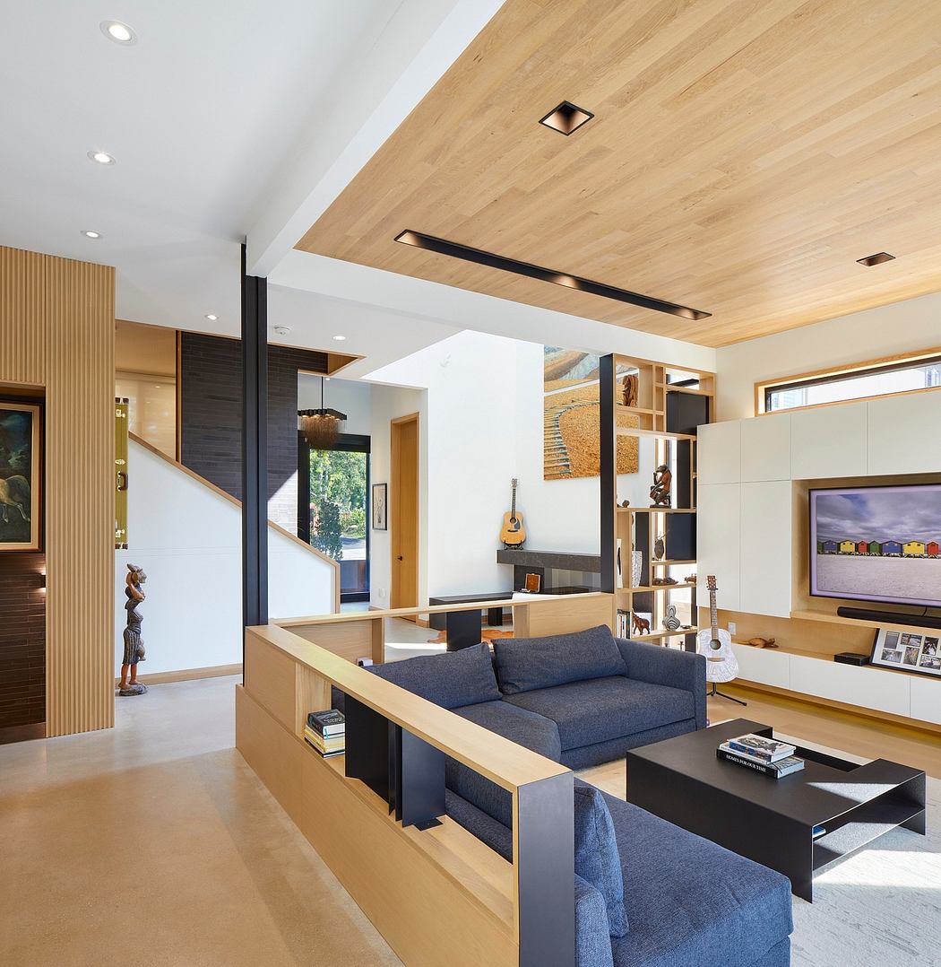 Open-concept living room with wood-paneled ceiling, built-in shelving, and modern furnishings.
