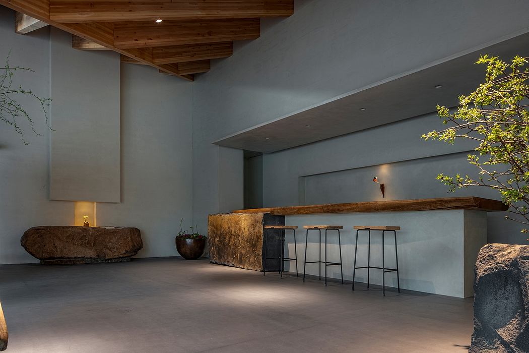 Minimalist interior with wooden beams, stone countertop, and modern furniture accents.