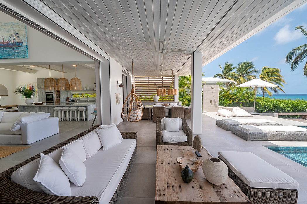Spacious open-concept beach home with modern tropical decor and panoramic ocean views.