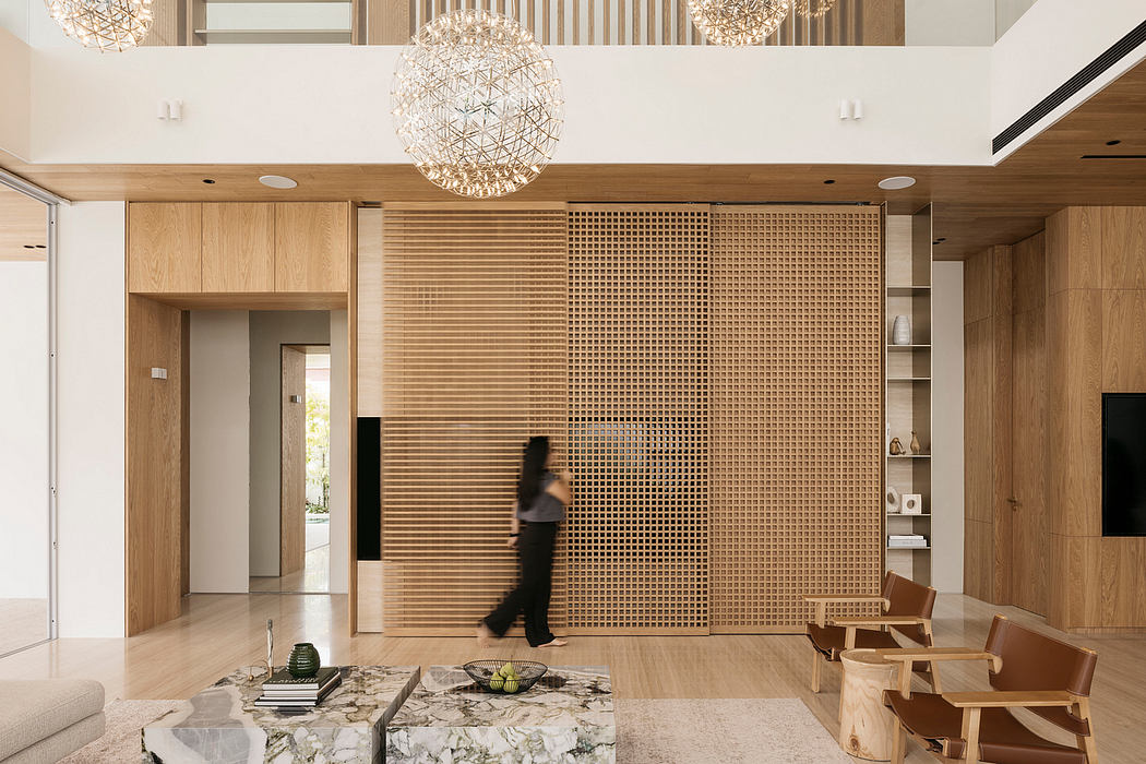 Spacious modern interior with wooden lattice wall, crystal chandeliers, and marble coffee table.