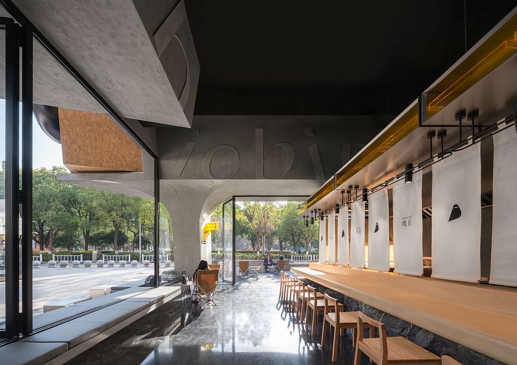 A modern, minimalist cafe space with concrete, wood, and glass elements, creating an inviting atmosphere.