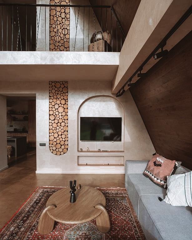 Rustic modern living room with wooden accents, arches, and decorative wall panels.