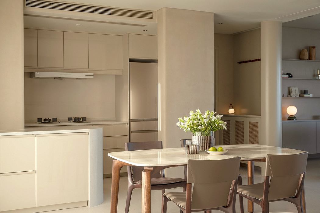Modern, minimalist kitchen and dining area with white cabinetry, wood accents, and sleek lighting.