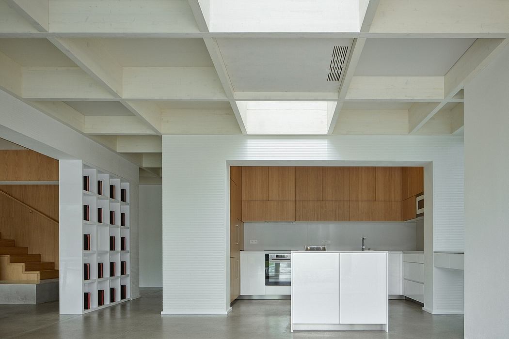 Minimalist kitchen and storage shelves in open, airy space with wooden accents.
