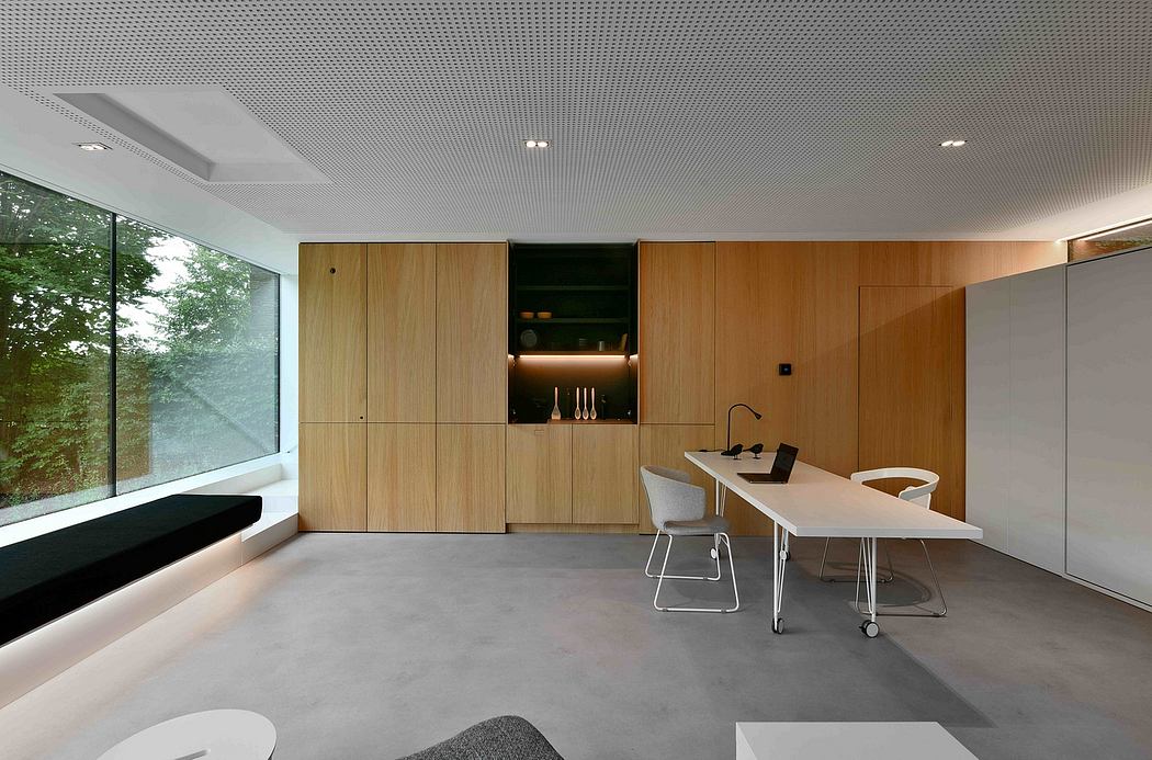 Minimal, modern interior with wood cabinetry, large window, and concrete floor.