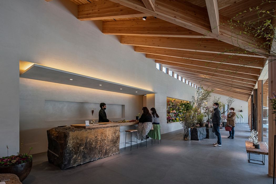 Warm, rustic wooden beams and a stone bar in a modern, minimalist interior.