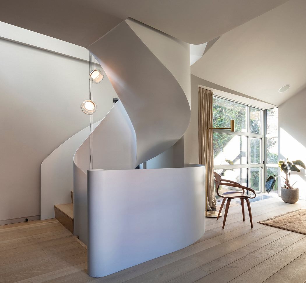 Captivating spiral staircase and minimalist furniture in a bright, spacious interior.