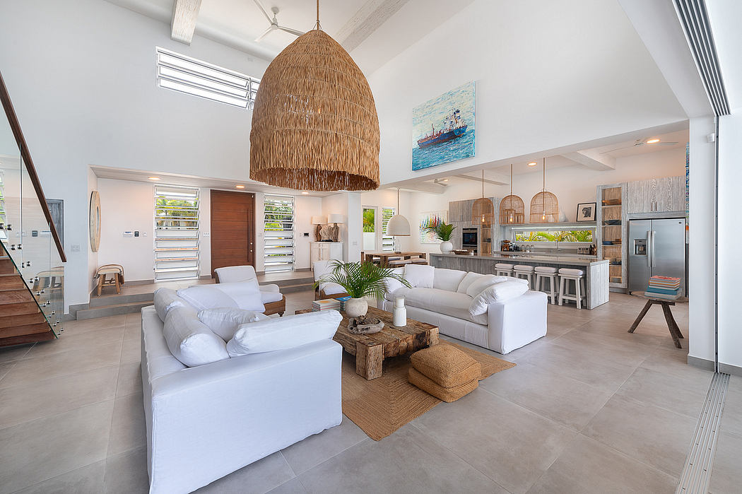 Open-concept living space with beige sofa, woven pendant light, and coastal-inspired artwork.
