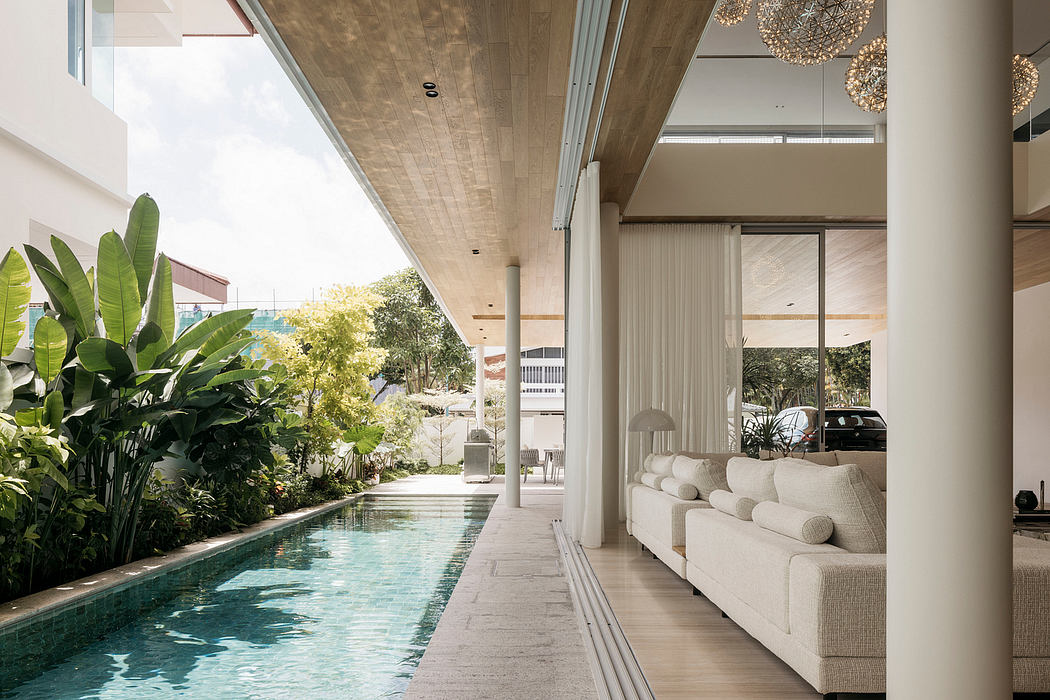 Elegant modern architecture featuring an indoor pool, lush greenery, and designer furnishings.