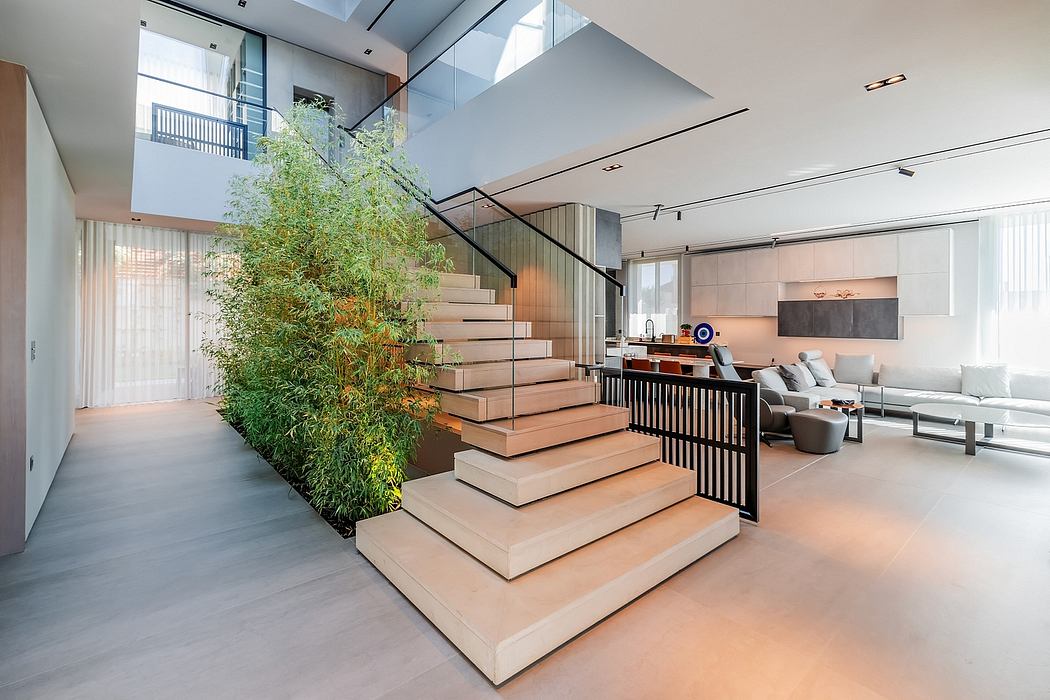 Elegant modern staircase with lush greenery, open living area, and sleek furniture.