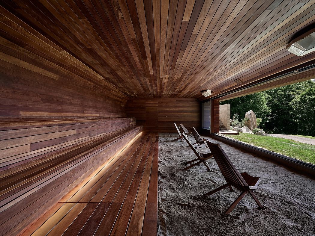 Expansive wooden ceiling and walls enclose a cozy outdoor lounge space.