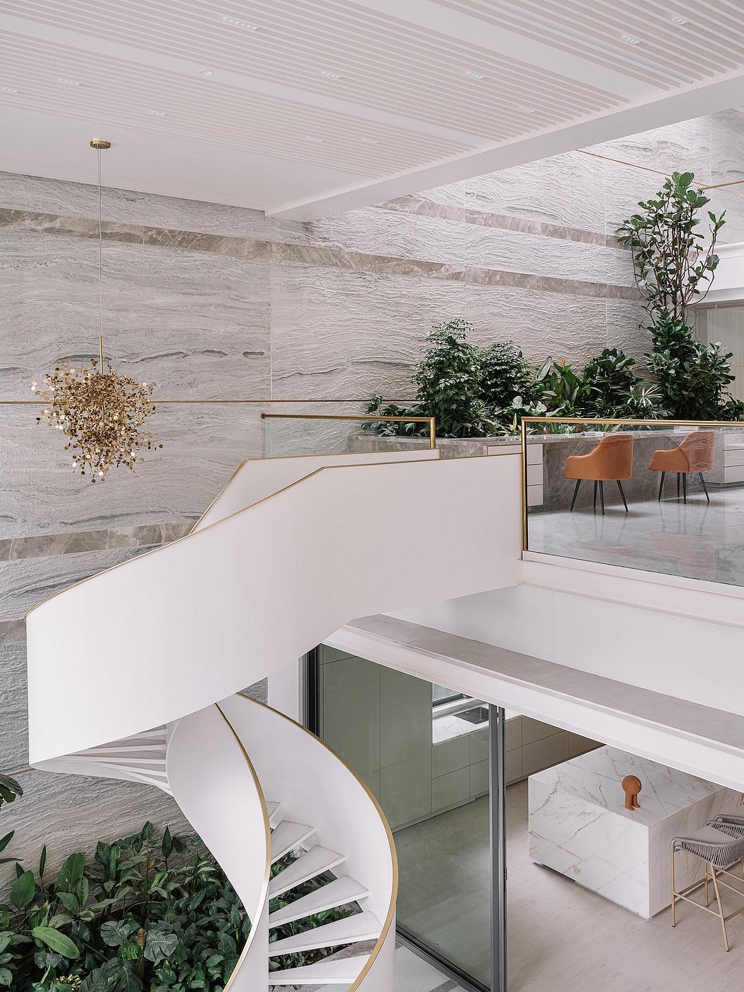 Elegant contemporary interior with marble accents, spiral staircase, and lush plants.