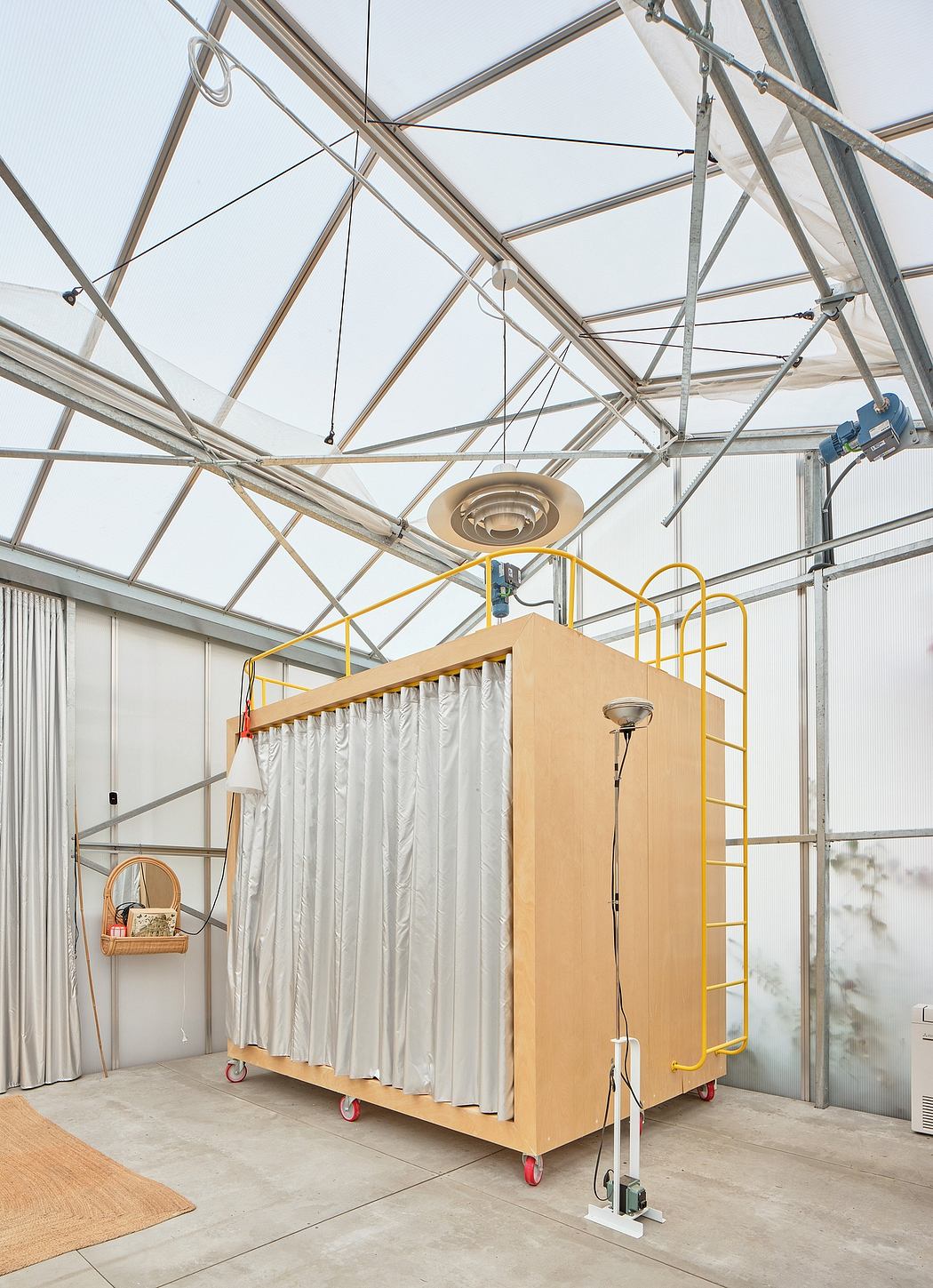 A spacious interior with a modular, mobile display unit on wheels and a glass ceiling.