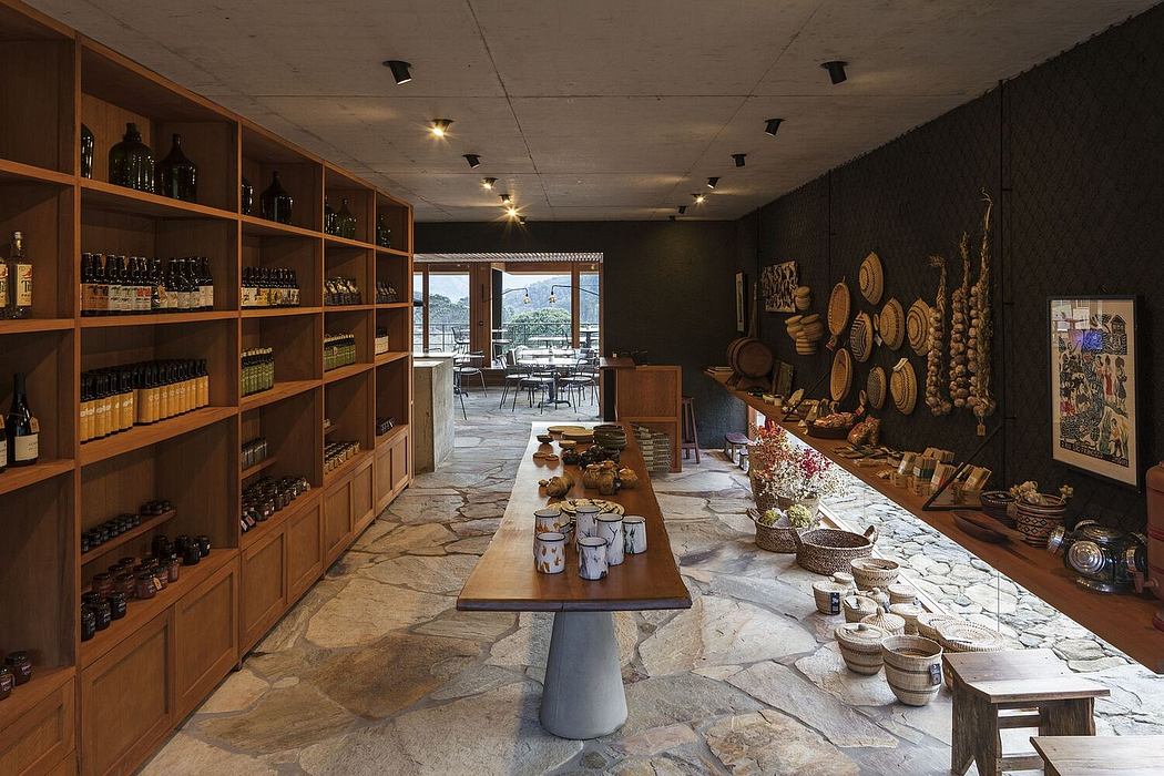 A cozy, rustic interior with wooden shelves, a stone floor, and a central dining table.