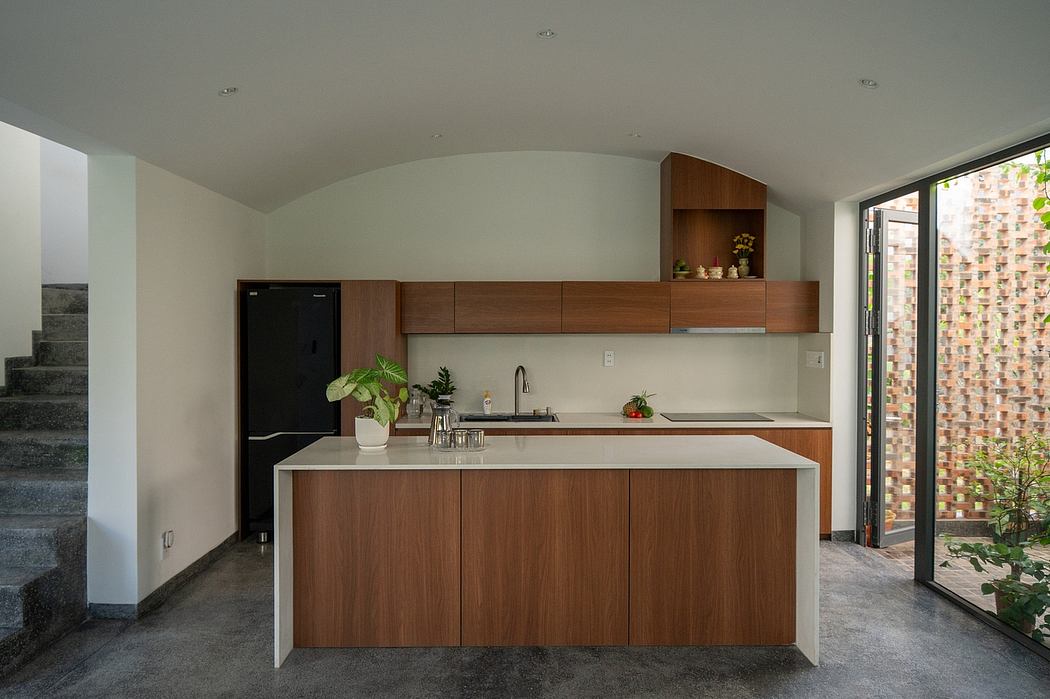 A modern kitchen with wooden cabinets, built-in shelving, and sleek, minimalist design.