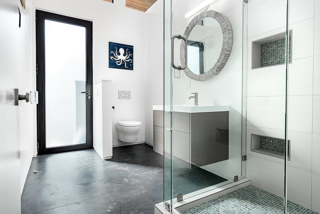 Modern bathroom with glass shower enclosure, vanity, and mosaic tile accents. Sleek design.