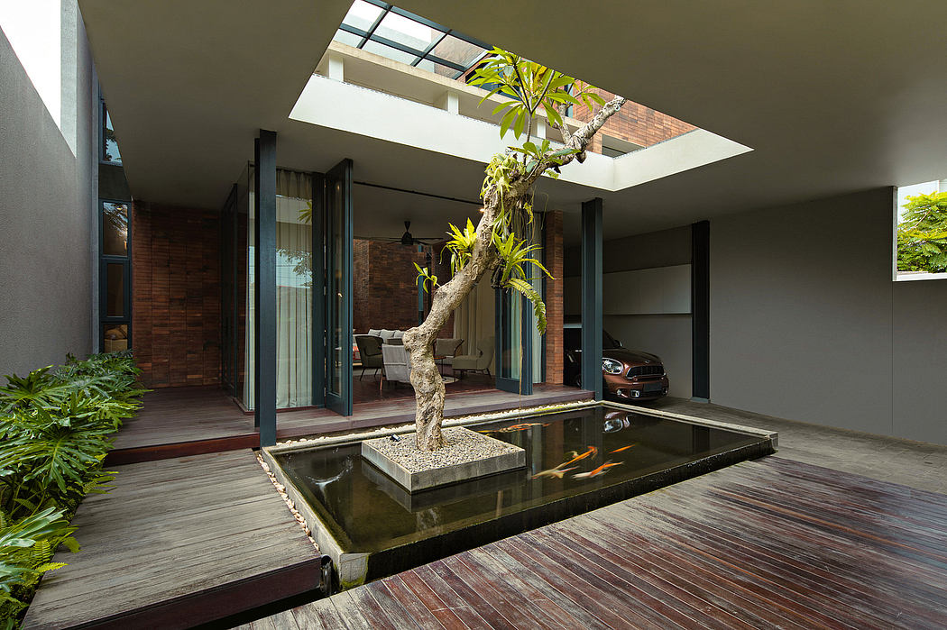 Spacious modern home with glass walls, reflecting pool, and natural elements.