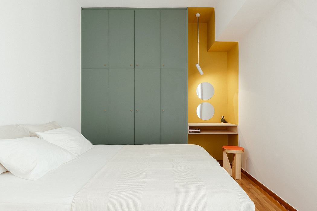 Modern bedroom design with built-in closet, wooden floors, and vibrant yellow accent.