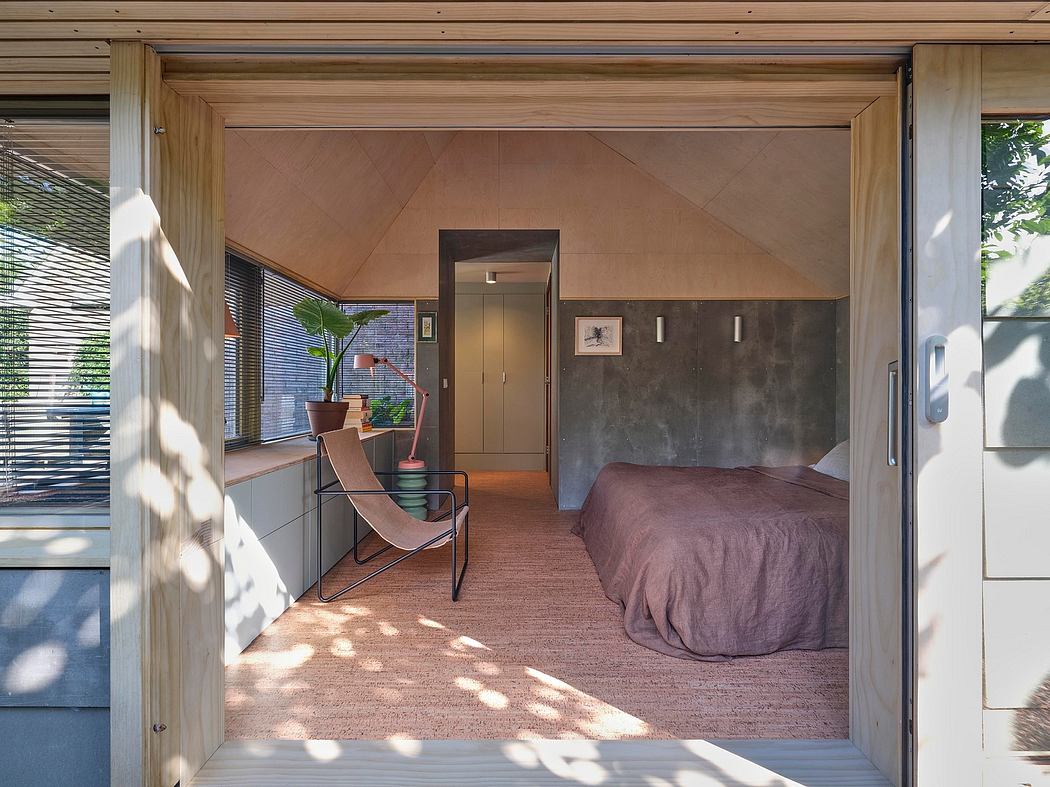 Warm, modern bedroom with vaulted ceilings, natural wood, and minimalist furniture.