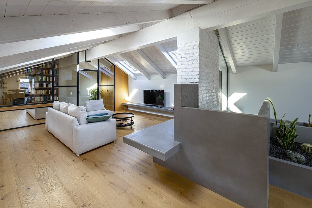 Spacious loft-style living room with exposed beams, brick accent wall, and built-in shelves.