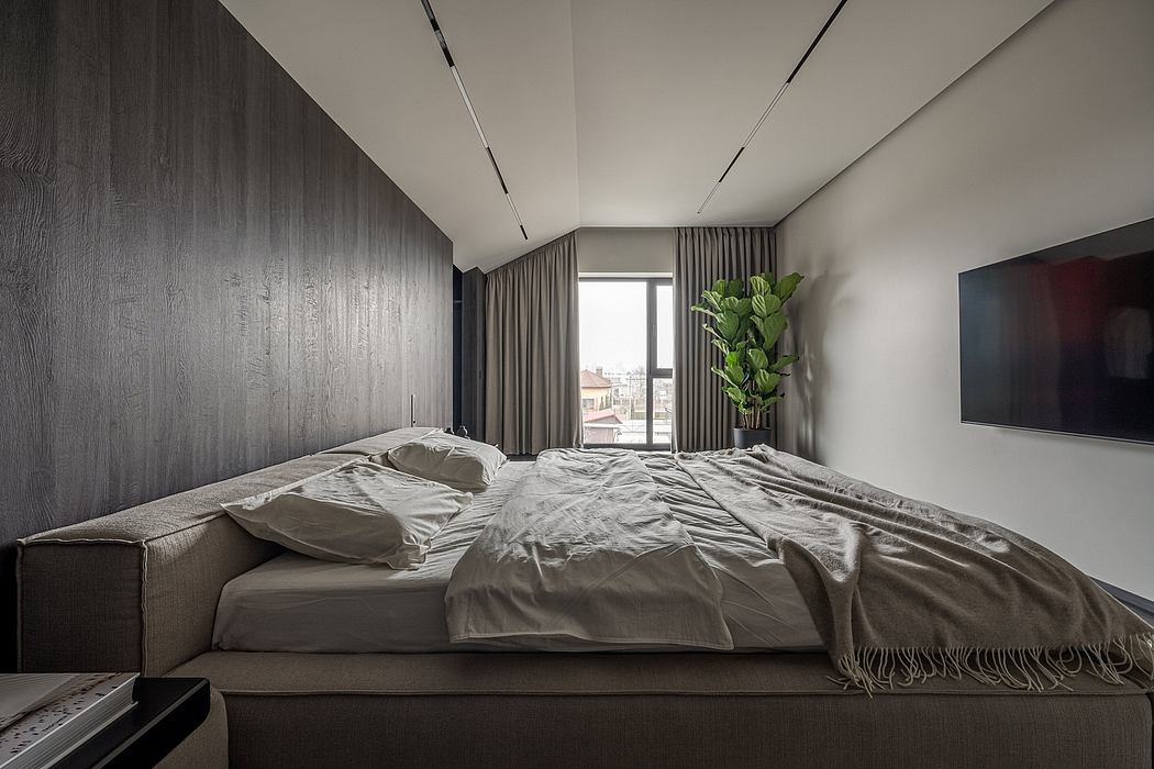 A modern, minimalist bedroom with a large bed, dark wood paneling, and a floor-to-ceiling window.