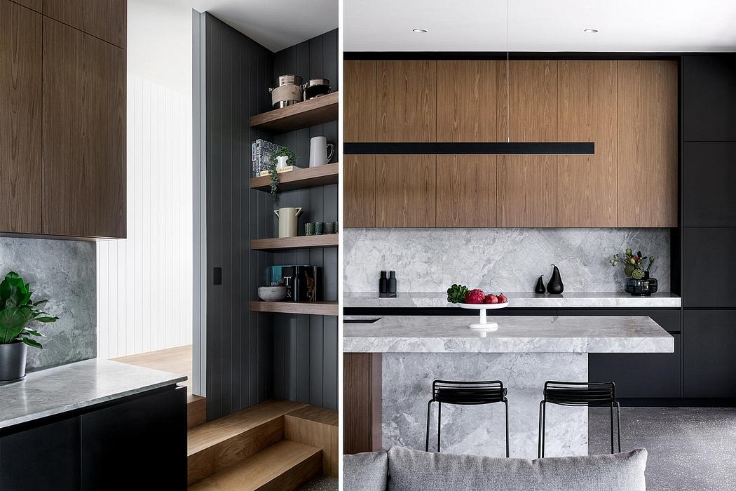 Modern kitchen with sleek dark cabinetry, marble countertops, and open shelving.