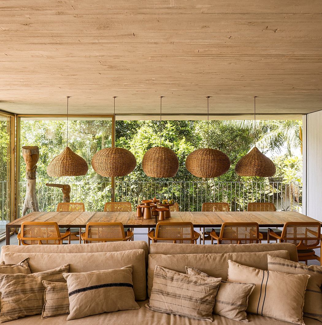 Spacious, nature-inspired dining area with woven pendant lights, wooden table, and cozy sofa.