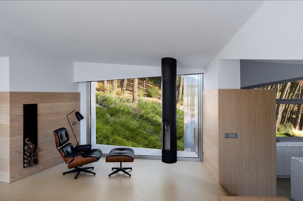 Minimalist living room with wood paneling, large window, and Eames-style chairs.