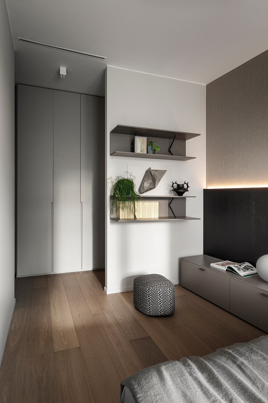 Minimalist bedroom with built-in storage, floating shelves, and textured accents.