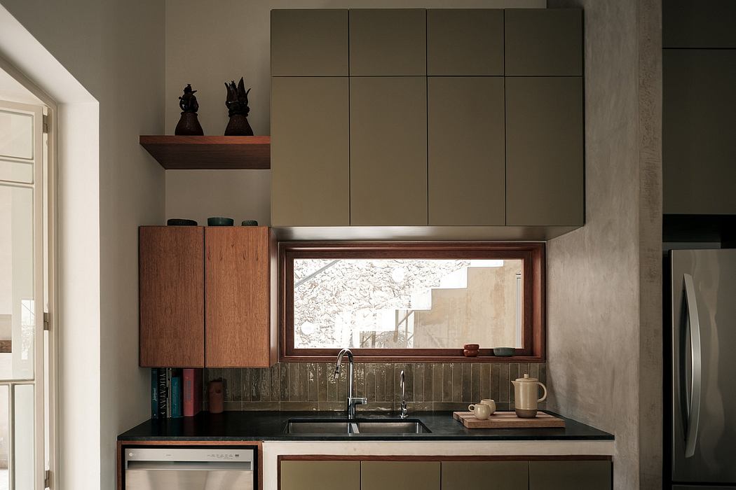 A modern, minimalist kitchen with sleek cabinetry, a large window, and a wooden shelf.