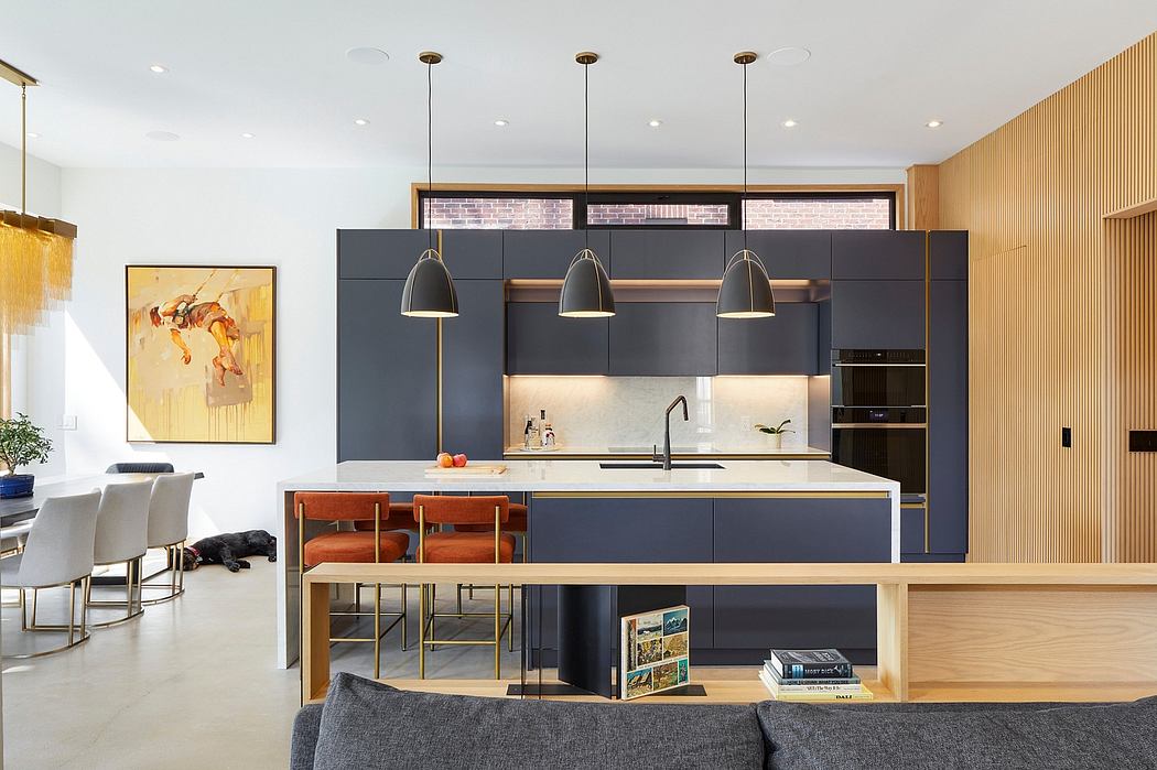 An open-concept kitchen and living space with sleek black cabinetry, pendant lights, and wooden accents.