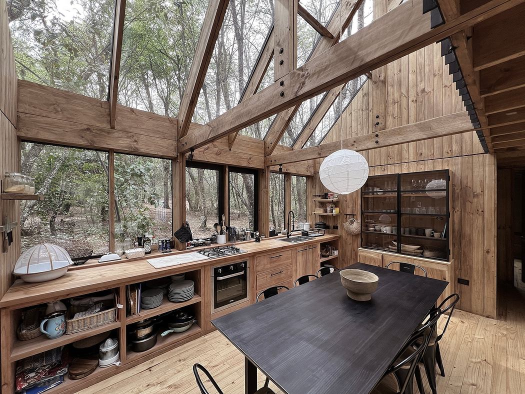 Rustic cabin kitchen with vaulted wood-beamed ceiling, abundant shelving, and large windows.