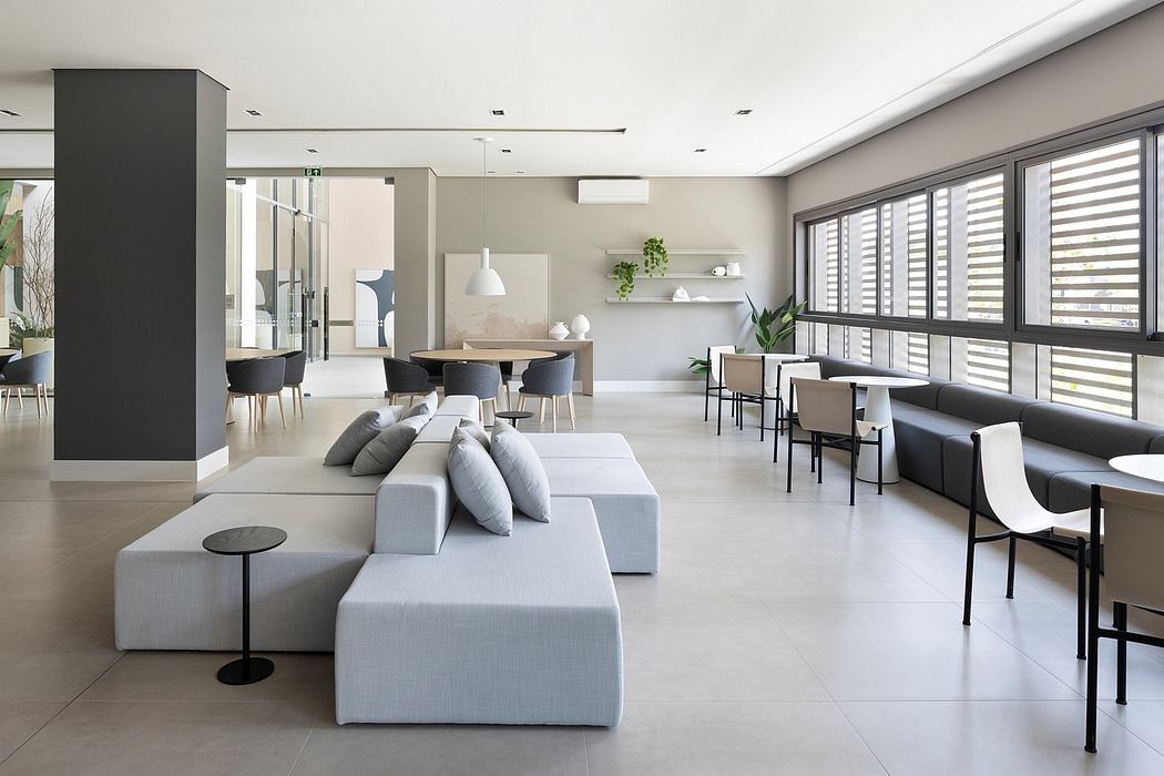 Bright, modern living space with minimalist furniture, clean lines, and large windows.