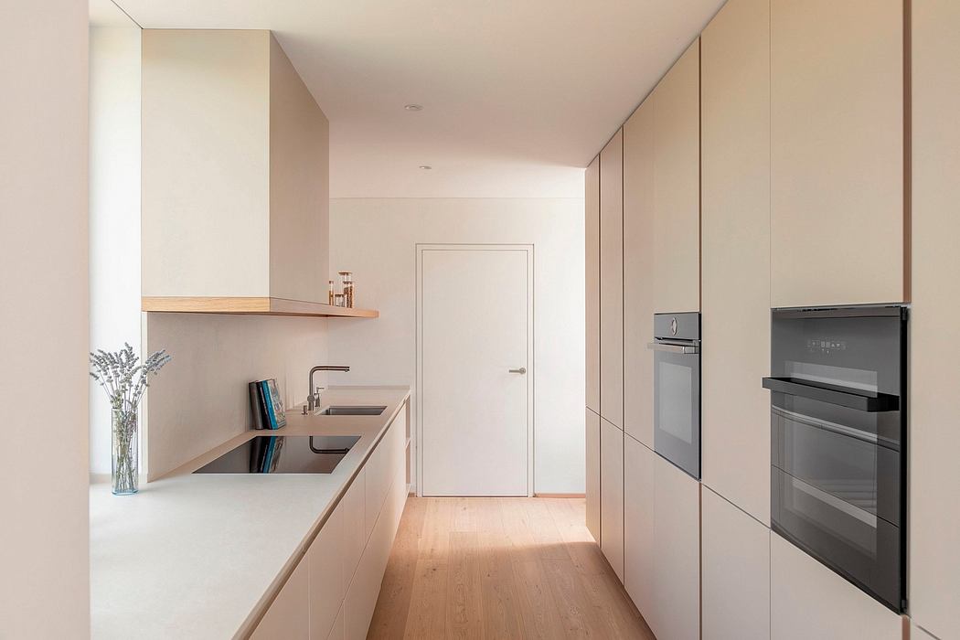 Sleek, modern kitchen design with minimalist cabinetry, wood accents, and built-in appliances.