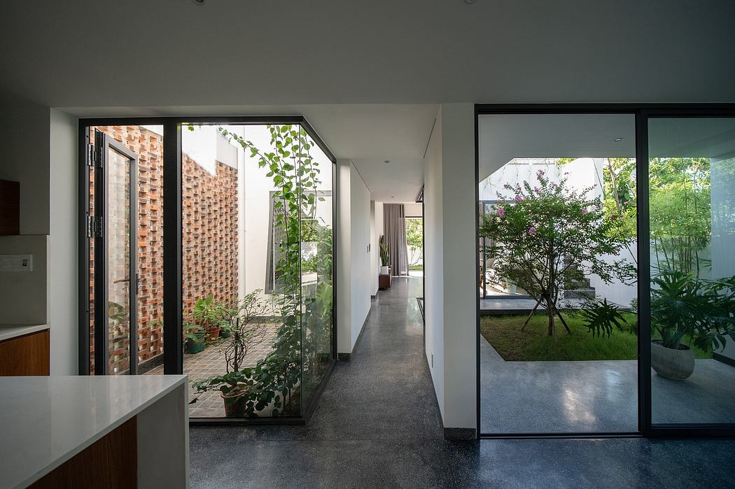 Minimalist design with brick walls, large windows, and a verdant courtyard garden.