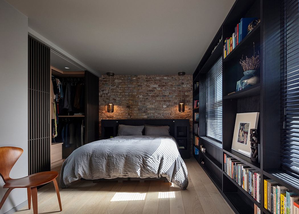 Cozy bedroom with exposed brick wall, built-in shelving, and warm lighting accents.