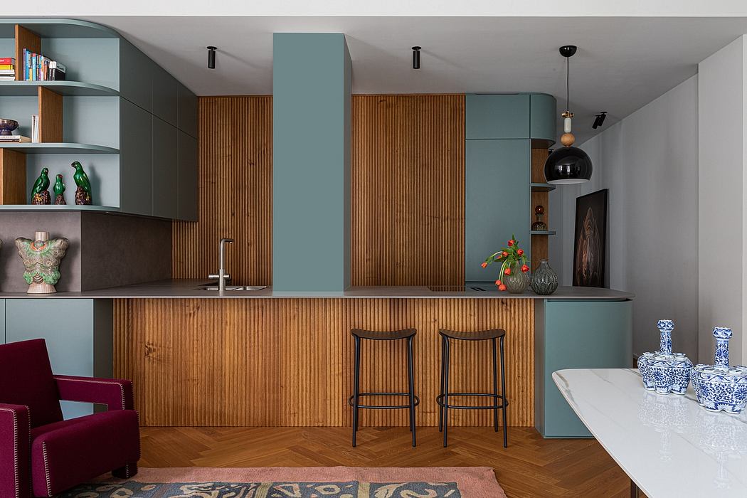 A modern, minimalistic kitchen and living space with wooden paneling, built-in shelves, and a striking teal color scheme.