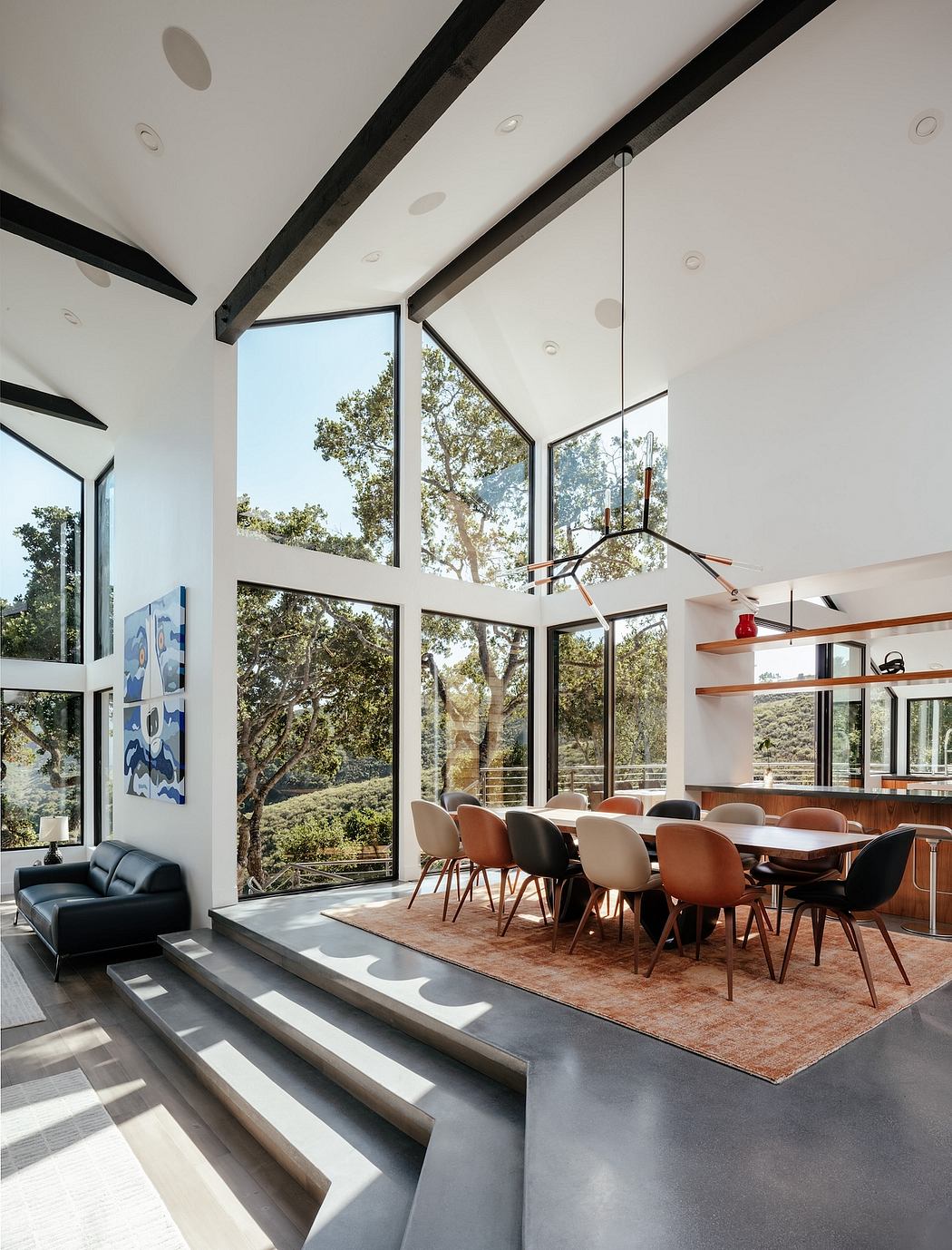 Spacious open-concept living area with floor-to-ceiling windows, modern furnishings, and architectural details.