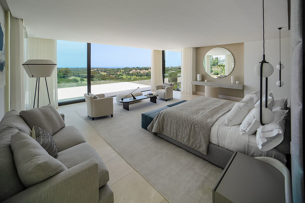 Spacious bedroom with panoramic windows, minimalist decor, and scenic countryside view.