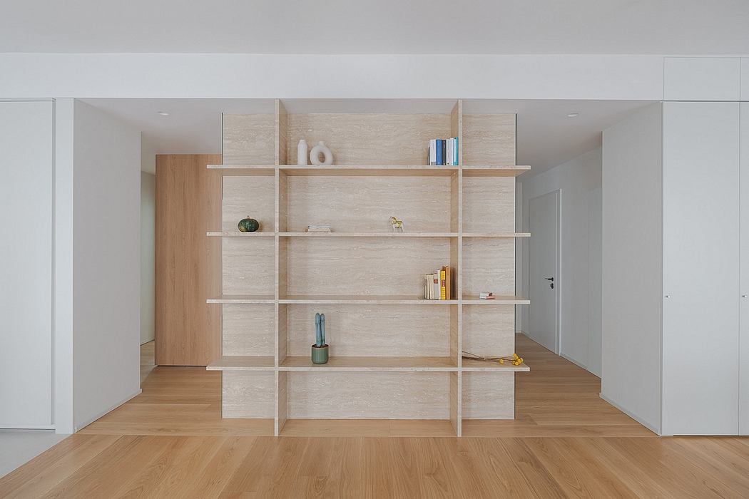 Minimalist living room with modern wooden shelving system and hardwood floor.